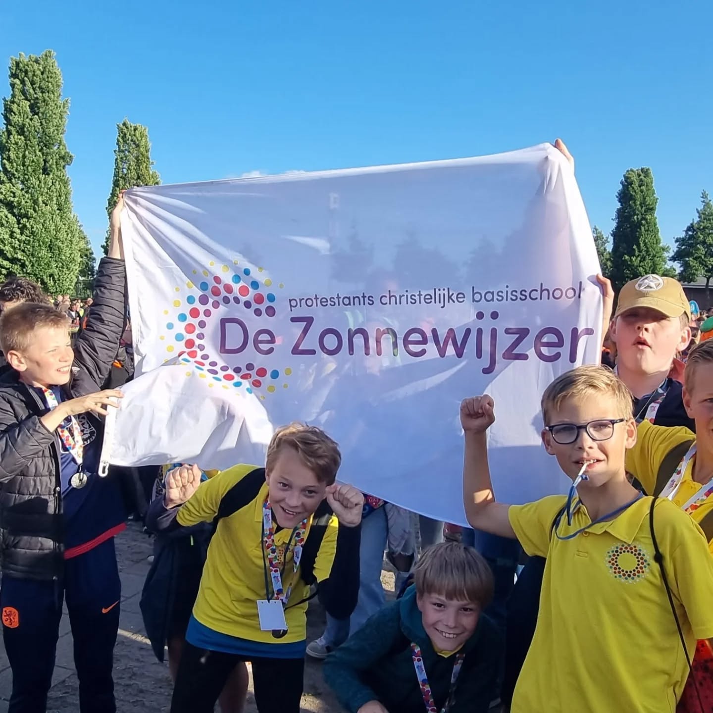 A field of grass with the sun setting in the background (by Sapan Patel on Unsplash)